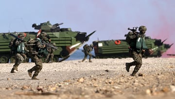 Soldiers exit from AAV7 amphibious assault vehicle run to position during an Amphibious landing drill as part of the Han Kuang military exercise in Pingtung, Taiwan, July 28, 2022. REUTERS/Ann Wang