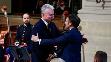 French President Emmanuel Macron greets Lithuania's President Gitanas Nauseda before a concert at Saint-Louis des Invalides cathedral, in Paris, France, March 12, 2024. REUTERS/Gonzalo Fuentes/Pool