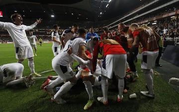 Serbia celebrate Aleksandar Mitrovic's late winner in Portugal - a goal that earned the Serbs automatic qualification at their hosts' expense.