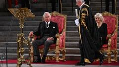 Britain's Speaker of The Commons Lindsay Hoyle (2R) walks past Britain's Camilla, Queen Consort (R) to hand a document to Britain's King Charles III during the presentation of Addresses by both Houses of Parliament in Westminster Hall, inside the Palace of Westminster, central London on September 12, 2022, following the death of Queen Elizabeth II on September 8. (Photo by Ben Stansall / various sources / AFP) (Photo by BEN STANSALL/AFP via Getty Images)