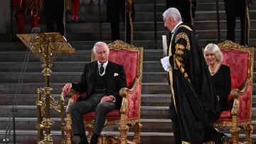 Britain's Speaker of The Commons Lindsay Hoyle (2R) walks past Britain's Camilla, Queen Consort (R) to hand a document to Britain's King Charles III during the presentation of Addresses by both Houses of Parliament in Westminster Hall, inside the Palace of Westminster, central London on September 12, 2022, following the death of Queen Elizabeth II on September 8. (Photo by Ben Stansall / various sources / AFP) (Photo by BEN STANSALL/AFP via Getty Images)