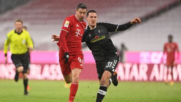 Bayern Munich's Polish forward Robert Lewandowski (L) and Freiburg's German defender Keven Schlotterbeck vie for the ball during the German first division Bundesliga football match between Bayern Munich and SC Freiburg in Munich, on January 17,