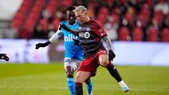 Apr 1, 2023; Toronto, Ontario, CAN; Toronto FC forward Federico Bernardeschi (10) battles for the ball with Charlotte FC defender Harrison Afful (25) during the second half at BMO Field. Mandatory Credit: John E. Sokolowski-USA TODAY Sports