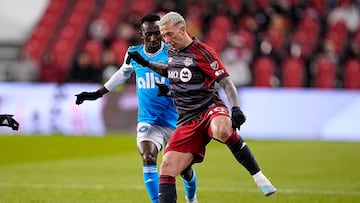 Apr 1, 2023; Toronto, Ontario, CAN; Toronto FC forward Federico Bernardeschi (10) battles for the ball with Charlotte FC defender Harrison Afful (25) during the second half at BMO Field. Mandatory Credit: John E. Sokolowski-USA TODAY Sports