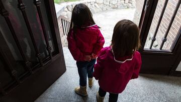 MADRID, SPAIN - APRIL 26: Two girls under the age of 14 are seen just before leaving home for the first time in weeks as Spain eases lockdown rules for children on April 26, 2020 in Madrid, Spain. Children in Spain, which has had one of the stricter lockd