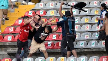 Supporters of Atlas fight with supporters of Queretaro during the Mexican Clausura tournament football match between Queretaro and Atlas at Corregidora stadium in Queretaro, Mexico on March 5, 2022. - A match between Mexican football clubs was called off 