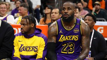 PHOENIX, ARIZONA - OCTOBER 28: Bronny James #9 and LeBron James #23 of the Los Angeles Lakers look on during the second half against the Phoenix Suns at Footprint Center on October 28, 2024 in Phoenix, Arizona. NOTE TO USER: User expressly acknowledges and agrees that, by downloading and or using this photograph, User is consenting to the terms and conditions of the Getty Images License Agreement. Christian Petersen/Getty Images/AFP (Photo by Christian Petersen / GETTY IMAGES NORTH AMERICA / Getty Images via AFP)