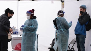 WASHINGTON, DC - DECEMBER 28: Healthcare workers administer COVID-19 PCR test at a free test site in Farragut Square on December 28, 2021 in Washington, DC. Yesterday the CDC announced that people should self-isolate for five days, instead of ten, after t