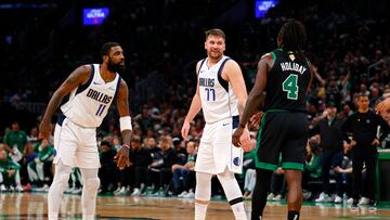 Dallas Mavericks guard Kyrie Irving (11) and guard Luka Doncic (77) react after a play against the Boston Celtics during the first quarter in game two of the 2024 NBA Finals at TD Garden.