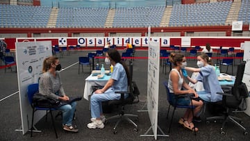 (FILES) In this file photo taken on May 31, 2021 Health workers vaccinate people against Covid-19 at the Donostia Arena former bullring in San Sebastian on May 31, 2021. - With the highest Covid-19 vaccination rate of Europe&#039;s big nations, Spain has 