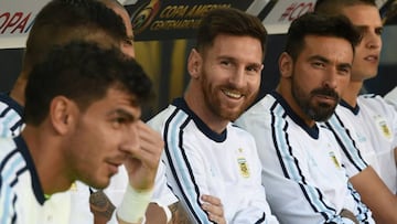 Argentina's Lionel Messi (C) smiles from the bench during a Copa America Centenario football match against Chile in Santa Clara, California, United States, on June 6, 2016. / AFP PHOTO / Mark Ralston
