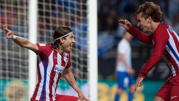 Atletico Madrid's Italian defender Filipe Luis (L) celebrates with French forward Antoine Griezmann after scoring during the Spanish league football match Malaga CF vs Club Atletico de Madrid at La Rosaleda stadium in Malaga on April 1, 2017. / AFP PHOTO / JORGE GUERRERO