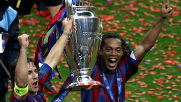 Barcelona's Ronaldinho celebrates with Carles Puyol after winning the Champions League final against Arsenal at the Stade de France in Saint Denis near Paris May 17, 2006.