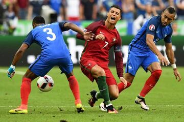 France's forward Dimitri Payet as he challenges Cristiano Ronaldo.