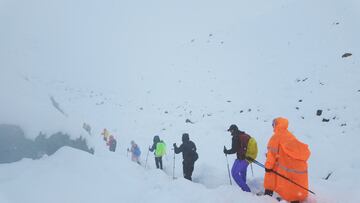 A screen capture from video shows trekkers leaving their campsite, as unusually heavy snow and rainfall pummeled the Himalayas, in the Tibet Region, China, October 5, 2025. Geshuang Chen/Handout via REUTERS. THIS IMAGE HAS BEEN SUPPLIED BY A THIRD PARTY NO RESALES. NO ARCHIVES. MANDATORY CREDIT