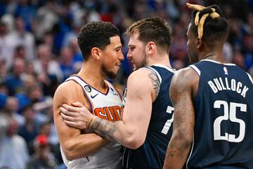 Mar 5, 2023; Dallas, Texas, USA; Phoenix Suns guard Devin Booker (1) and Dallas Mavericks guard Luka Doncic (77) exchange words and have to be separated late in the fourth quarter at the American Airlines Center. Mandatory Credit: Jerome Miron-USA TODAY Sports