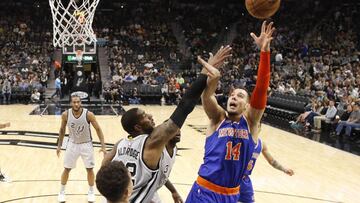 Mar 25, 2017; San Antonio, TX, USA; New York Knicks center Willy Hernangomez (14) shoots the ball over San Antonio Spurs power forward LaMarcus Aldridge (12) during the second half at AT&T Center. The Spurs won 106-98. Mandatory Credit: Soobum Im-USA TODAY Sports
