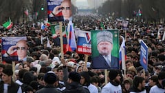 People, including supporters of Russian incumbent President and presidential candidate Vladimir Putin, take part in a procession organized on the occasion of the upcoming presidential election, in the Chechen capital Grozny, Russia, March 10, 2024. One of the posters displays an image of Russian President Vladimir Putin and reads: "Choice of truth!" REUTERS/Chingis Kondarov