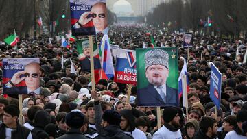 People, including supporters of Russian incumbent President and presidential candidate Vladimir Putin, take part in a procession organized on the occasion of the upcoming presidential election, in the Chechen capital Grozny, Russia, March 10, 2024. One of the posters displays an image of Russian President Vladimir Putin and reads: "Choice of truth!" REUTERS/Chingis Kondarov