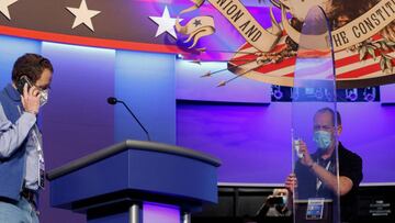 FILE PHOTO: A worker cleans the plexiglass shields onstage at the site of the second and final debate between 2020 U.S. presidential candidates President Donald Trump and Democratic nominee and former Vice President Joe Biden at the Curb Event Center that