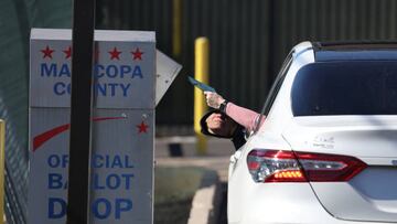 PHOENIX, ARIZONA - NOVEMBER 06: A voter drops their ballot into a drop box outside of the Maricopa County Tabulation and Election Center on November 06, 2022 in Phoenix, Arizona. With two days to go until election day, early voting continues as Arizona voters are preparing for close midterm election races. (Photo by Justin Sullivan/Getty Images)