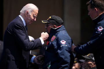 President Joe Biden greets WW II veteran Richard Stewart after he was awarded in the Legion of Honor by French President Emmanuel Macron, during a commemorative ceremony to mark D-Day 80th anniversary, Thursday, June 6, 2024 at the US cemetery in Colleville-sur-Mer, Normandy.  Daniel Cole/Pool via REUTERS