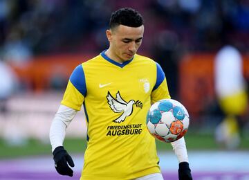 FC Augsburg v Borussia Dortmund - WWK Arena, Augsburg, Germany - February 27, 2022 FC Augsburg's Ruben Vargas is seen with a jersey saying City of peace Ausburg in support of Ukraine during the warm up before the match
