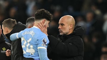 Manchester City's Croatian defender #24 Josko Gvardiol speaks with Manchester City's Spanish manager Pep Guardiola after picking up an injury during the English Premier League football match between Manchester City and Chelsea at the Etihad Stadium in Manchester, north west England, on January 4, 2026. Manchester City have confirmed defender Josko Gvardiol suffered a broken leg in Sunday's 1-1 draw with Chelsea at the Etihad Stadium. (Photo by Oli SCARFF / AFP) / RESTRICTED TO EDITORIAL USE. No use with unauthorized audio, video, data, fixture lists, club/league logos or 'live' services. Online in-match use limited to 120 images. An additional 40 images may be used in extra time. No video emulation. Social media in-match use limited to 120 images. An additional 40 images may be used in extra time. No use in betting publications, games or single club/league/player publications. /