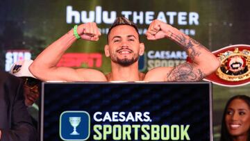 NEW YORK, NEW YORK - JUNE 17: Robeisy Ramirez flexes on the scale during the weigh in with Abraham Nova, ahead of their featherweight fight, at The Hulu Theater at Madison Square Garden on June 17, 2022 in New York City. (Photo by Mikey Williams/Top Rank Inc via Getty Images)