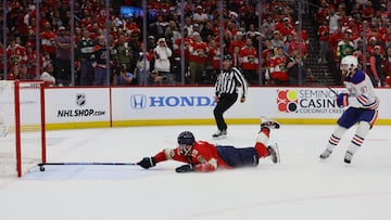 Jun 18, 2024; Sunrise, Florida, USA; Florida Panthers forward Matthew Tkachuk (19) reaches for the puck on an empty net attempt on goal by Edmonton Oilers forward Connor McDavid (97) during the third period in game five of the 2024 Stanley Cup Final at Amerant Bank Arena. Mandatory Credit: Sam Navarro-USA TODAY Sports