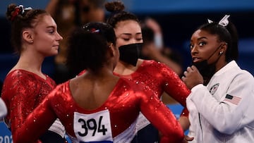 USA's Simone Biles (R) speaks with her teammates during the artistic gymnastics women's team final during the Tokyo 2020 Olympic Games at the Ariake Gymnastics Centre in Tokyo on July 27, 2021.