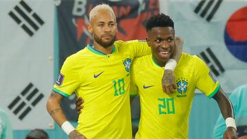 Brazil's forward #20 Vinicius Junior (R) celebrates scoring his team's first goal with Brazil's forward #10 Neymar during the Qatar 2022 World Cup round of 16 football match between Brazil and South Korea at Stadium 974 in Doha on December 5, 2022. (Photo by Odd ANDERSEN / AFP)