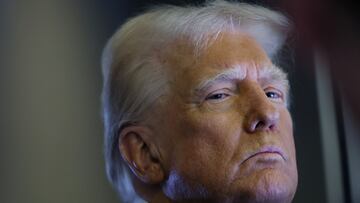 U.S. President Donald Trump looks on as reporters ask questions aboard Air Force One during a flight from Las Vegas, Nevada, to Miami, Florida, U.S., January 25, 2025. REUTERS/Leah Millis