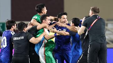 Uzbekistan's players celebrate after their 2026 FIFA World Cup Asian Qualifier football match against the United Arab Emirates ended in a draw, qualifying them for the World Cup for the first time, at Al-Nahyan Stadium�in Abu Dhabi on June 5, 2025. (Photo by Fadel SENNA / AFP)