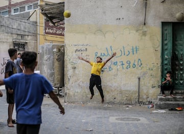 Ni?os refugiados palestinos juegan al ftbol frente a sus hogares en el campamento de Jabalia, en el norte de la Franja de Gaza.