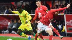 Brest&#039;s French midfielder Julien Faussurier (R) and Brest&#039;s French midfielder Mathias Autret (C) vie with Nantes&#039; Nigerian forward Moses Simon (L) during the French L1 football match between Brest and Nantes on November 23, 2019, at the Fra