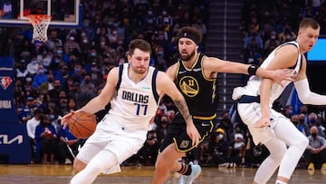 Jan 25, 2022; San Francisco, California, USA; Dallas Mavericks guard Luka Doncic (77) dribbles the ball against Golden State Warriors guard Klay Thompson (11) during the second quarter at Chase Center. Mandatory Credit: Kelley L Cox-USA TODAY Sports