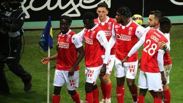 Reims' French forward Nathanael Mbuku (L) celebrates with teammates after scoring his team's second goal during the French L1 football match between Stade de Reims and AS Saint-Etienne at the Auguste Delaune Stadium in Reims, northeastern France