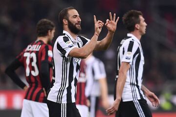Juventus' forward Gonzalo Higuain from Argentina celebrates after scoring during the Italian Serie A football match AC Milan Vs Juventus on October 28, 2017 at the 'Giuseppe Meazza' Stadium in Milan.