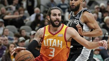 Utah Jazz guard Ricky Rubio (3) drives around San Antonio Spurs guard Patty Mills during the second half of an NBA basketball game, Sunday, Dec. 9, 2018, in San Antonio. San Antonio won 110-97. (AP Photo/Darren Abate)