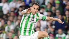 Real Betis' Mexican midfielder #18 Andres Guardado jumps over Real Madrid's Brazilian forward #11 Rodrygo during the Spanish league football match between Real Betis and Real Madrid CF at the Benito Villamarin stadium in Seville on December 9, 2023. (Photo by CRISTINA QUICLER / AFP)