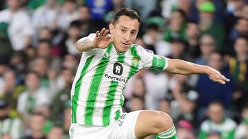 Real Betis' Mexican midfielder #18 Andres Guardado jumps over Real Madrid's Brazilian forward #11 Rodrygo during the Spanish league football match between Real Betis and Real Madrid CF at the Benito Villamarin stadium in Seville on December 9, 2023. (Photo by CRISTINA QUICLER / AFP)