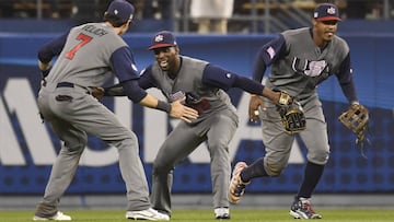 Mar 21, 2017; Los Angeles, CA, USA; United States outfielder Christian Yelich (7), United States outfielder Andrew McCutchen (22) and United States outfielder Adam Jones (10) celebrate the team&#039;s 2-1 win over Japan during the 2017 World Baseball Classic at Dodger Stadium. Mandatory Credit: Robert Hanashiro-USA TODAY Sports