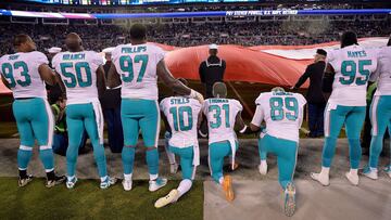 CHARLOTTE, NC - NOVEMBER 13: Miami Dolphins players kneel during the national anthem before their game against the Carolina Panthers at Bank of America Stadium on November 13, 2017 in Charlotte, North Carolina. Grant Halverson/Getty Images/AFP
== FOR NEWSPAPERS, INTERNET, TELCOS & TELEVISION USE ONLY ==