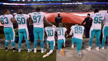 CHARLOTTE, NC - NOVEMBER 13: Miami Dolphins players kneel during the national anthem before their game against the Carolina Panthers at Bank of America Stadium on November 13, 2017 in Charlotte, North Carolina.   Grant Halverson/Getty Images/AFP
 == FOR NEWSPAPERS, INTERNET, TELCOS &amp; TELEVISION USE ONLY ==