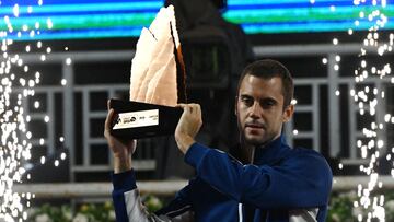 Serbia'a Laslo Djere holds up the trophy after beating after beating Argentina's Sebastian Baez during their ATP Santiago Open men's singles tennis final match at the Club San Carlos de Apoquindo in Santiago on March 2, 2025. (Photo by RODRIGO ARANGUA / AFP)