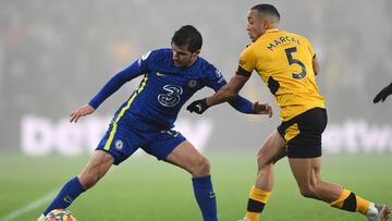 WOLVERHAMPTON, ENGLAND - DECEMBER 19: Mason Mount of Chelsea is challenged by Marcal of Wolverhampton Wanderers during the Premier League match between Wolverhampton Wanderers and Chelsea at Molineux on December 19, 2021 in Wolverhampton, England. (Photo