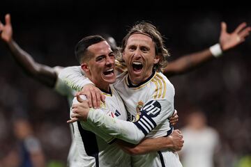 Soccer Football - LaLiga - Real Madrid v Sevilla - Santiago Bernabeu, Madrid, Spain - February 25, 2024  Real Madrid's Luka Modric celebrates scoring their first goal with Lucas Vazquez REUTERS/Violeta Santos Moura