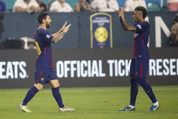 Neymar and Messi celebrate a goal.