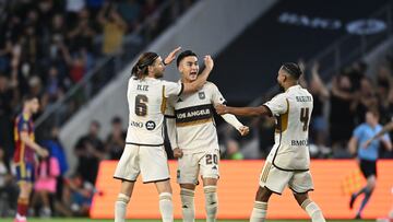 Jul 17, 2024; Los Angeles, California, USA; LAFC midfielder Eduard Atuesta (20) reacts with midfielder Ilie Sanchez (6) during the first half at BMO Stadium. Mandatory Credit: Jonathan Hui-USA TODAY Sports
